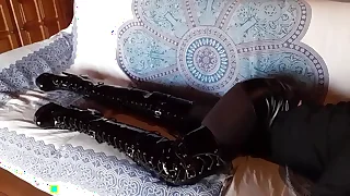 Total black with fishnets pantyhose and boots over make an issue of knee